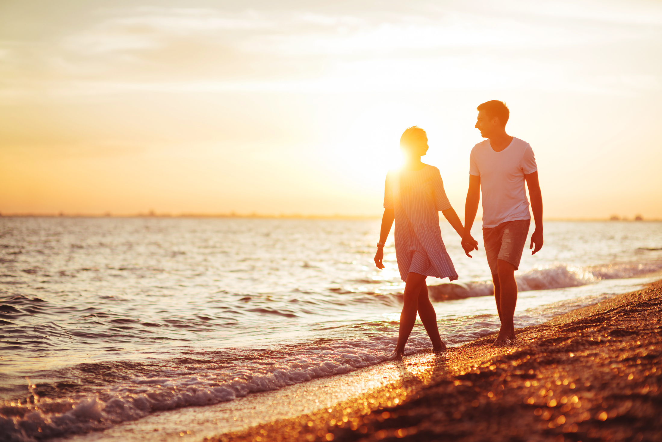 Young happy couple on seashore.