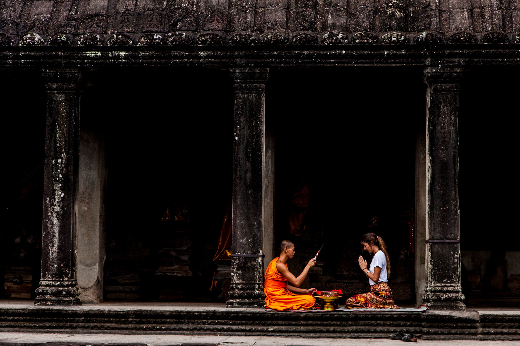 Woman Sitting in Front of Monk